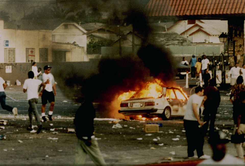 A car burns as looters take to the streets at the intersection of Florence and Normandie Avenues, April 29, 1992, This intersection is considered the flashpoint of the Los Angeles riots. (Photo by Steve Grayson/WireImage)