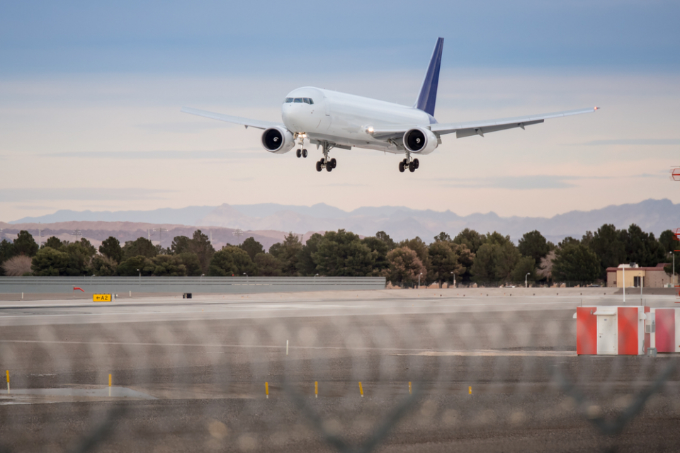No logo Airplane landing on runway with blue sky sunset Photo Credit: Sky Sajjaphot