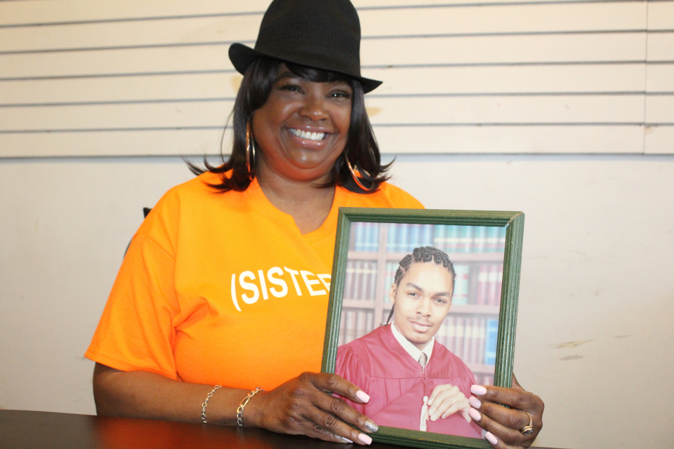 Cheryl Myles holding a picture of her son Kyle Myles - Photo Credit: Eddy "Precise" Lamarre