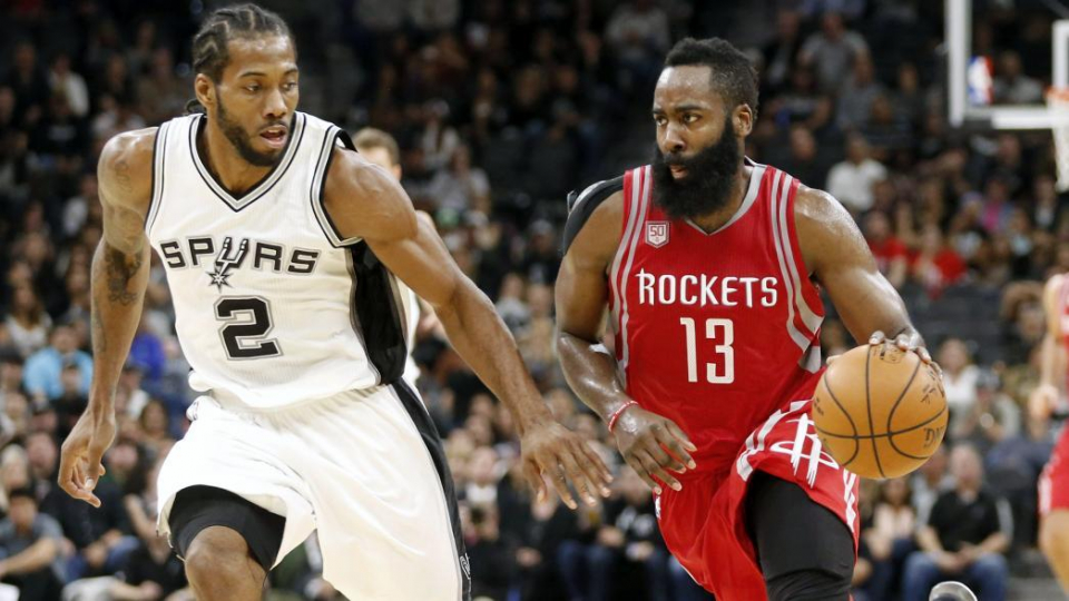 (Photo from @HoustonRockets/Twitter) Houston Rockets guard James Harden drives against San Antonio Spurs forward Kawhi Leonard.