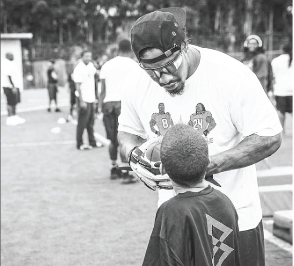 Marshawn Lynch sits during national anthem before NFL return