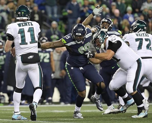 Seahawks' Quinton Jefferson tries to climb into stands to confront fans