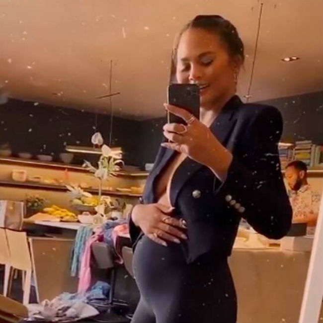 Chrissy Teigen shows off growing baby bump (video)