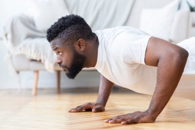 Young,Black,Man,Exercising,In,His,House,Gym,,Doing,Push