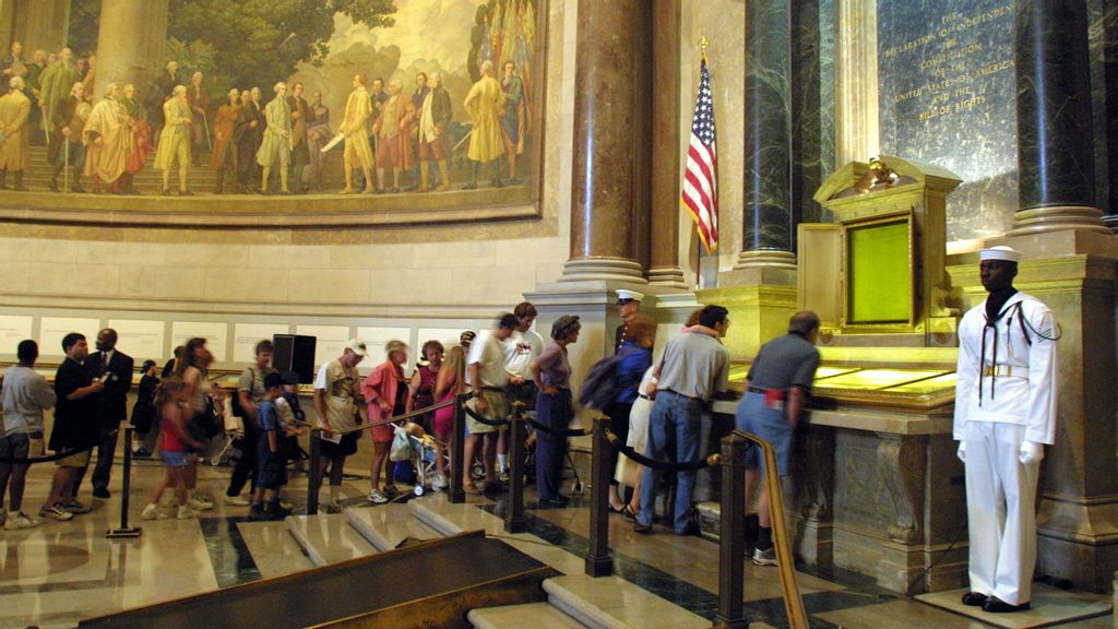 Visitors wait in line to view the original copies of the Declaration of Independence, the Constitution and the Bill of Rights July 4, 2001 at the National Archives in Washington, D. C. (Photo by Alex Wong/Getty Images)