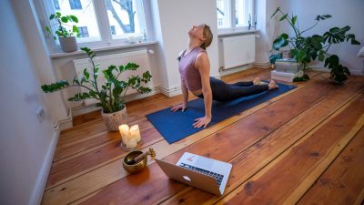 Marlene of Yoga on the Move Berlin warms up prior online stream session in her home on March 25, 2020 in Berlin, Germany. Small businesses are trying ways of offering services for clients in the midst of the COVID-19 pandemic. (Photo by Maja Hitij/Getty Images)