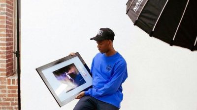 CJ Wolfe in his Immortal Vision Studio in Philadelphia with a prized photo from one of his shoots. (Asya Hall) 