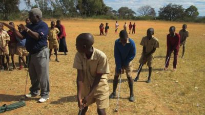 Tavenganiswa Mabikacheche, in dark-blue shirt at left, saw golf and the life skills it taught as a tool for rural development in his native Zimbabwe. (Mabikacheche Rural & Urban Sports Promotion Golf Foundation)