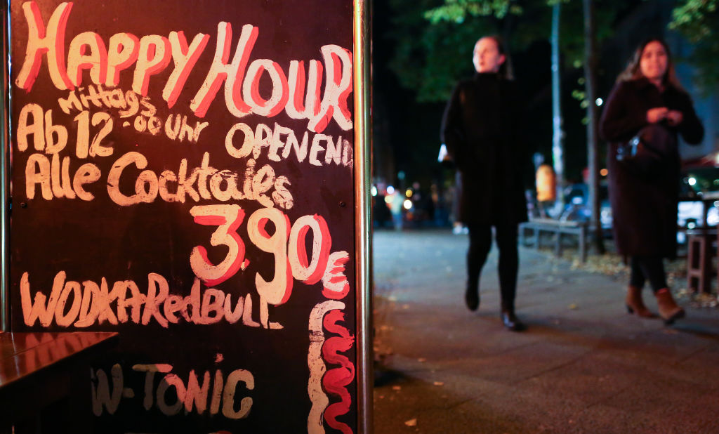 A sign advertises all-day Happy Hour cocktails for sale at a bar prior to its closing at 11pm on October 17, 2020 in Berlin, Germany. (Photo by Adam Berry/Getty Images)