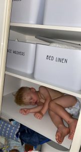 Meet the tot who will fall asleep anywhere but his own cot - including in his wardrobe, on a shelf and even on his pet dog. (Kate Johnston, SWNS/Zenger)