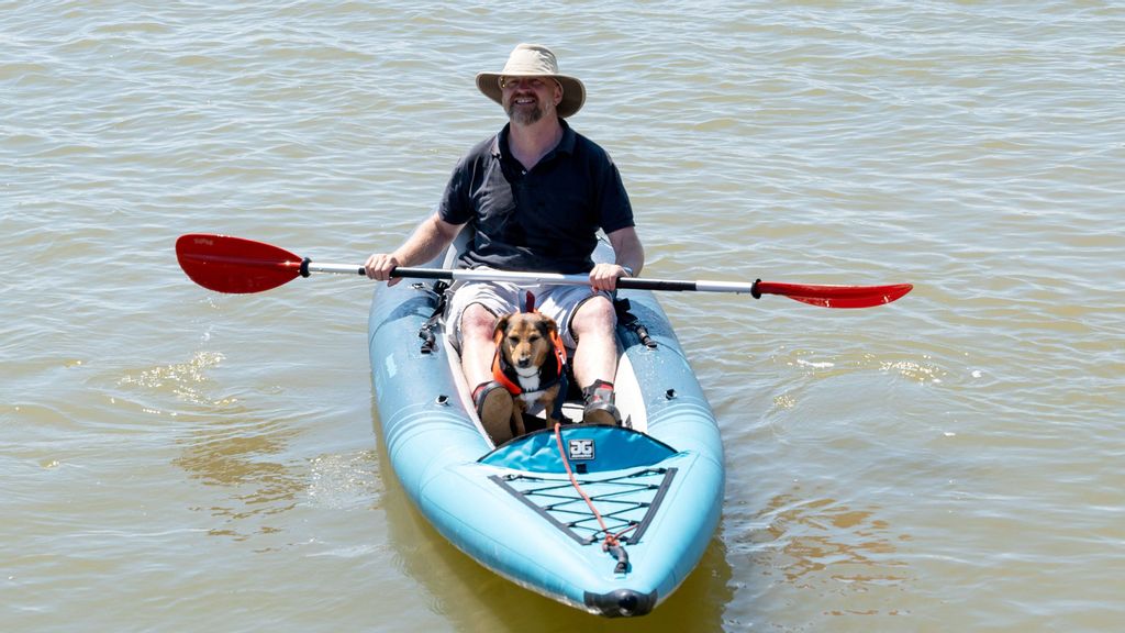 A man and his dog posing for a picture while kayaking. Half of dog owners have a 'bucket list' of memorable experiences they dream of sharing with their pet, including hiking up mountains, swimming in the sea and camping under the stars. (Jon Mills, SWSN/Zenger)
