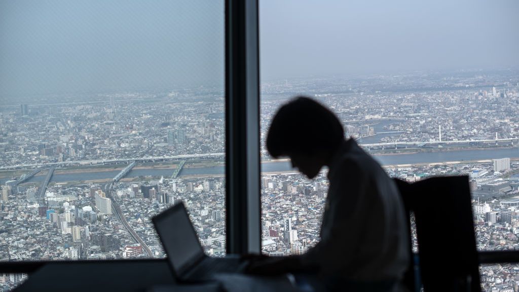 A cafe employee works on her laptop on the viewing platform of the Tokyo Skytree on March 29, 2018 in Tokyo, Japan.  (Photo by Carl Court/Getty Images)
