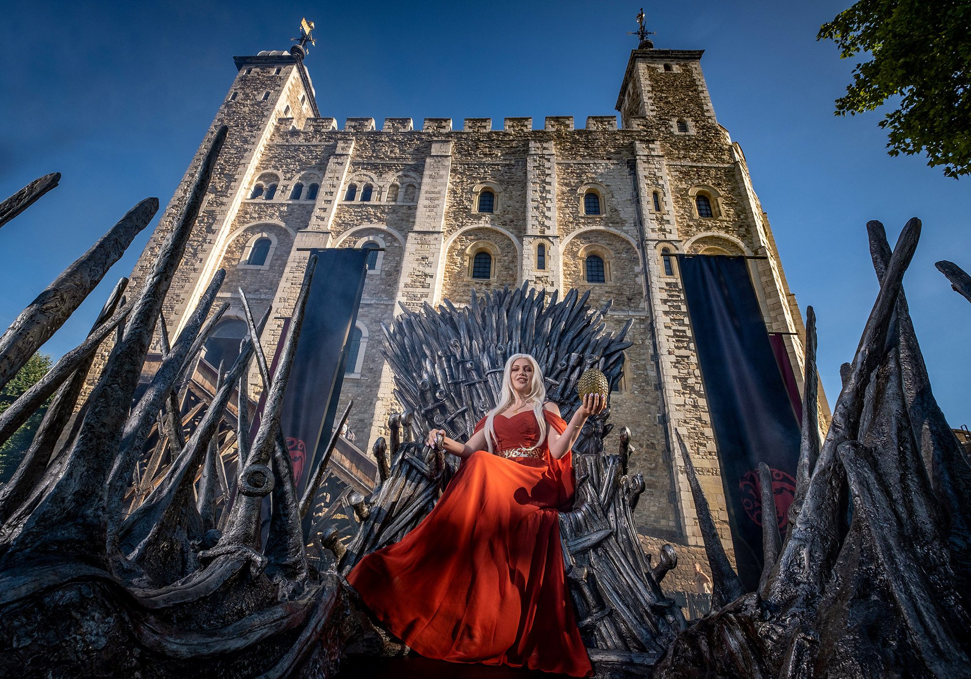 Cosplayer and superfan Sophia sits on the Iron Throne outside the Tower of London to mark the launch of the Game of Thrones prequel, House of the Dragon, in London, England, on Monday, August 8, 2022. (SWNS/Zenger)