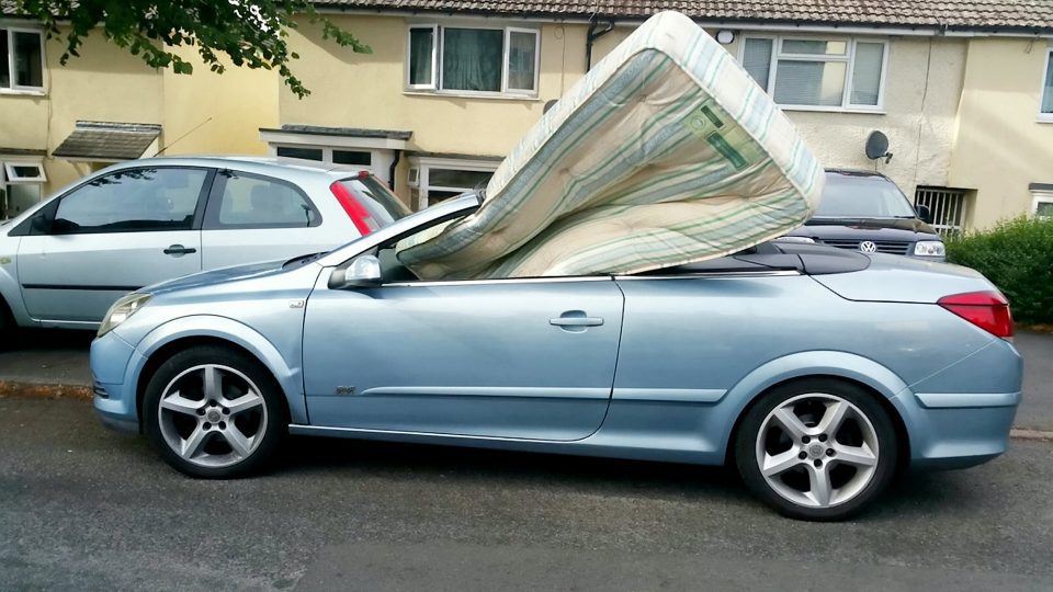 A mattress improperly stuffed in the front seat of a car, in undated photo. Drivers from around the United Kingdom lately have been driving the police crazy. (WMP,SWNS.com/Zenger)