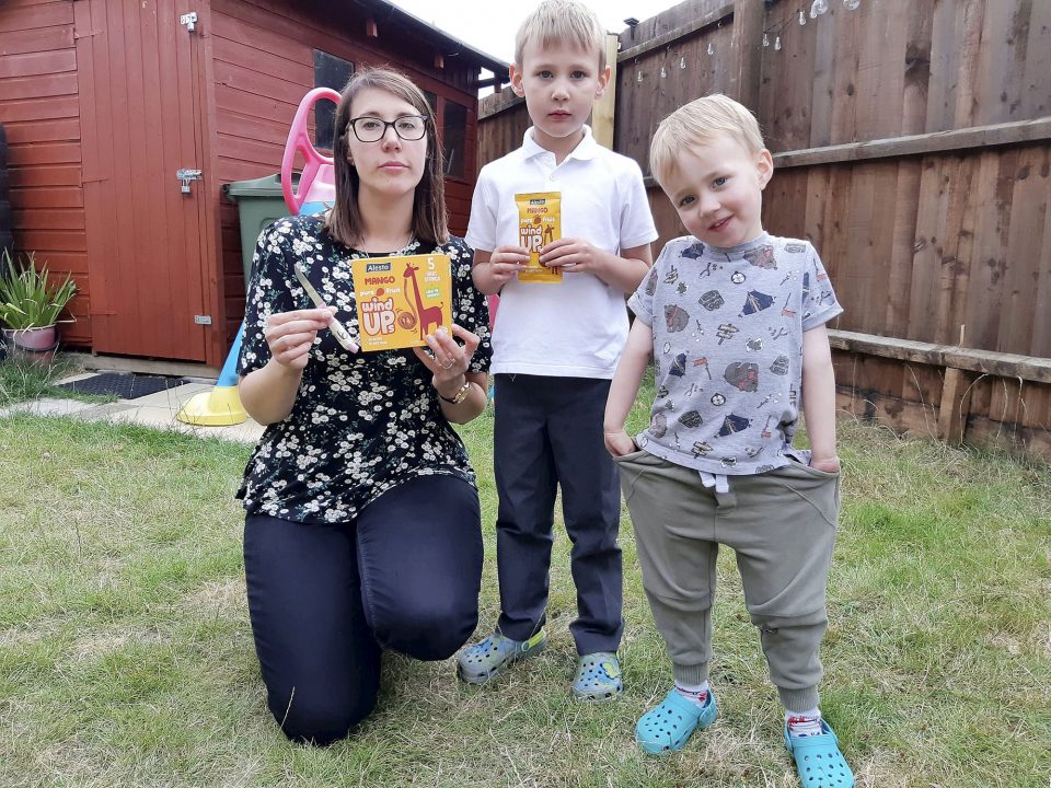 Tracey Croft and sons Kenneth (5) and Corey (3) pose with the knife in undated photograph. The mom-of-two was shocked to find a sharp knife in a box of children’s snacks. (Stamford Mercury, SWNS/Zenger)