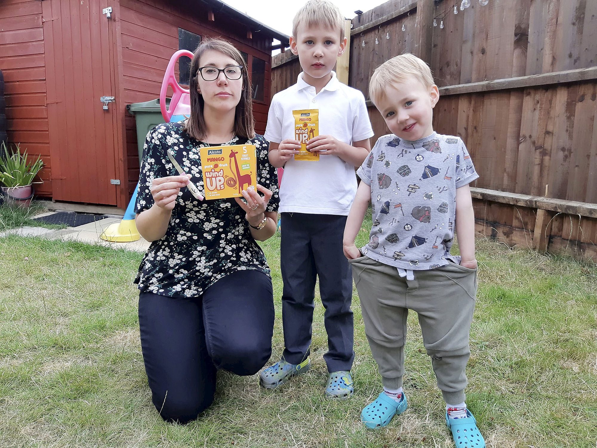 Tracey Croft and sons Kenneth (5) and Corey (3) pose with the knife in undated photograph. The mom-of-two was shocked to find a sharp knife in a box of children’s snacks. (Stamford Mercury, SWNS/Zenger)