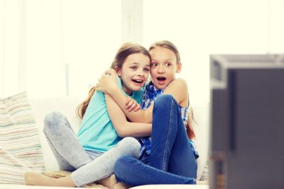 In this picture young girls react to a program on the television in this file photo. Watching violent content affects childrens performance in schools. GROUND  PICTURE VIA SHUTTERSTOCK 