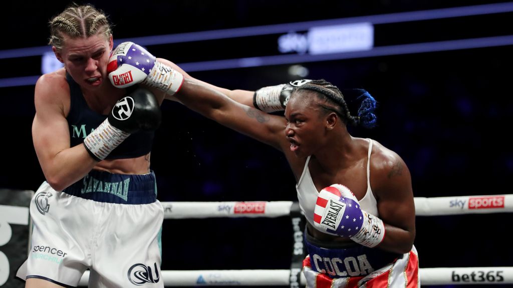 Claressa Shields (R) punches Savannah Marshall (L) during the IBF, WBA, WBC, WBO World Middleweight Title fight at the Shields vs Marshall Boxxer fight night. It was the first women's only boxing card in the UK at The O2 Arena on October 15, 2022 in London, England. JAMES CHANCE/GETTY IMAGES 