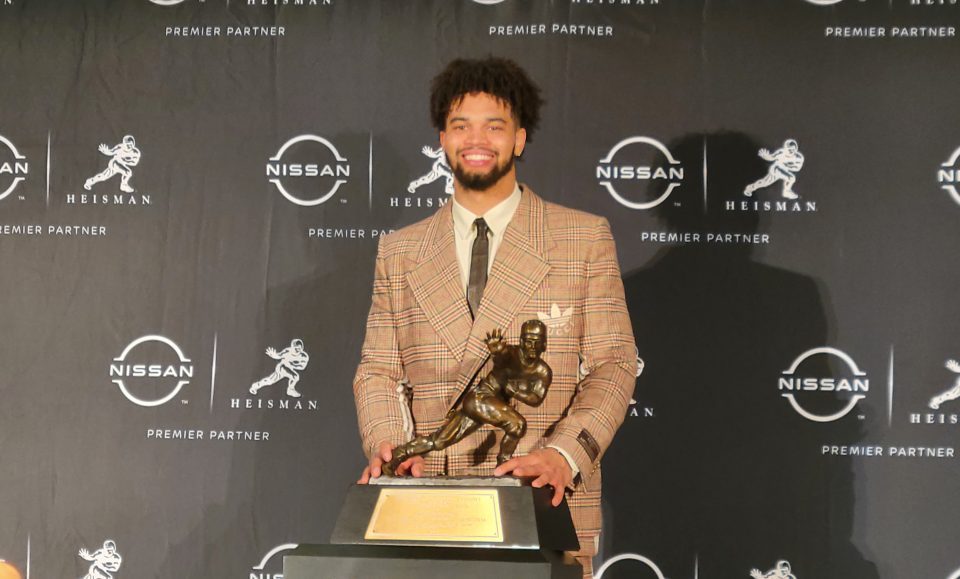 Caleb Williams, quarterback of the USC Trojans men's football team with the Heisman Trophy. (Photo by Derrel Jazz Johnson for rolling out)