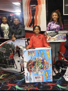 Mayor Andre Dickens awards proclamation to Ebony Austin at 3rd annual toy drive