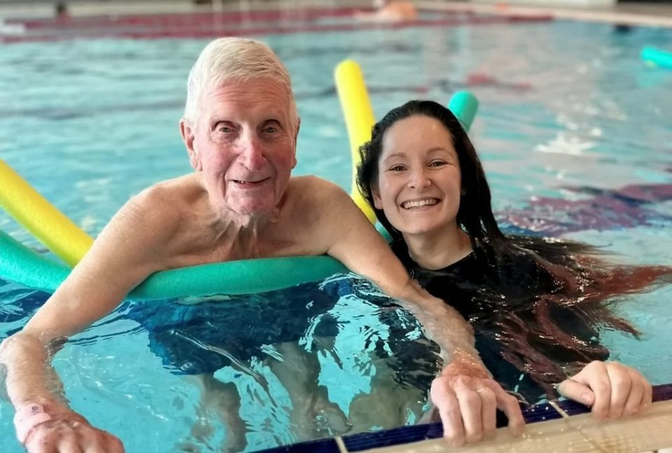 Veteran Roger Roberts and care assistant Holli Whitehouse in the water as Roger goes swimming for the first time since WW2. Nursing home bosses arranged for Roger Roberts to go for his first dip in 80 years after HMS Charybdis came under attack in the English Channel in 1943. FOLEY GRANGE CARE HOME/SWNS TALKER