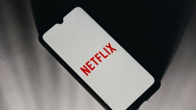 In this photo illustration a Netflix logo is displayed on a smartphone screen in Athens, Greece on January 18, 2023. Shareholders are hoping the streamer sheds light on the new plan during its fourth-quarter earnings report, which is due after the bell Thursday. NIKOLAS KOKOVLIS/BENZINGA