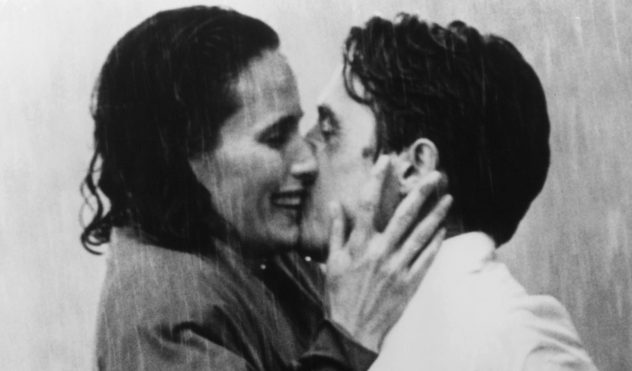 Andie MacDowell And Hugh Grant kiss in the rain in a scene from the film 'Four Weddings And A Funeral', 1994. Rom-coms have involved kissing in the rain in major blockbuster movies. GRAMERCY PICTURES/ACCUWEATHER