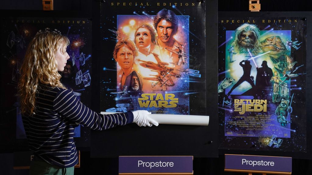 A Propstore employee adjusts one of a set of three Sir Alec Guinness autographed posters for the Star Wars Special Edition Trilogy (1997) during a preview for the showbiz memorabilia auction, at the Propstore in Rickmansworth, England. Luke Skywalker, Leia Organa and Han Solo could be coming back to life and starring in a new series of short films according to the latest Star Wars rumor. ANDREW MATTHEWS/BENZINGA