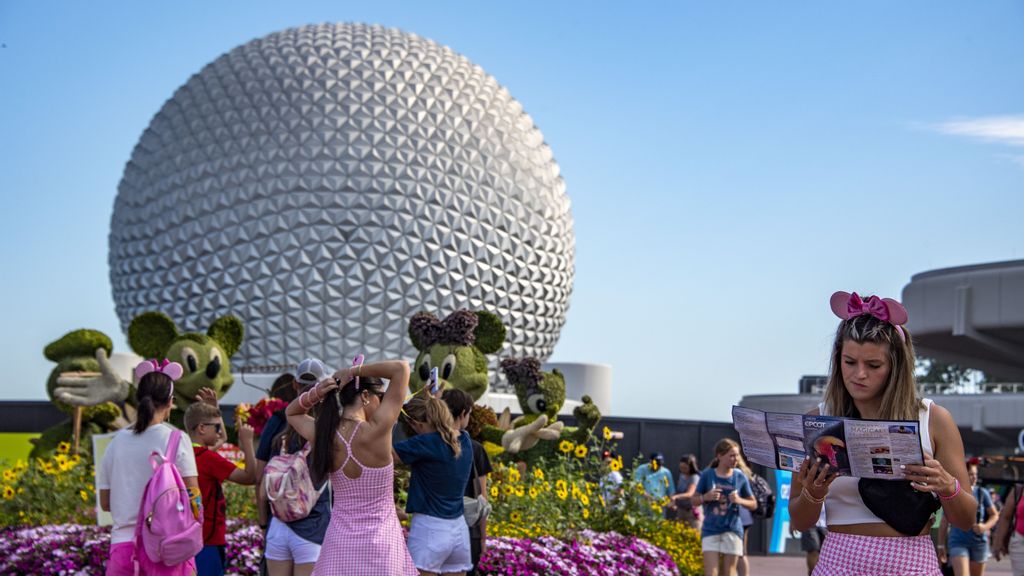 A tourist looks at a park map during the Flower and Garden Festival at Epcot at Walt Disney World in Orange County, Florida on May 30, 2022. Disney's ongoing embattlement with Florida Gov. Ron DeSantis as Disney had lost its self-governing status in Florida. JOSEPH PREZIOSO/BENZINGA