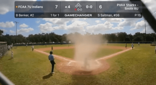 Little League umpire rescues player from a mini-tornado