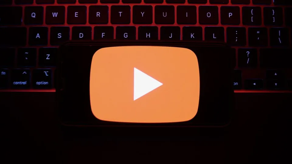 A laptop keyboard and YouTube logo displayed on a phone screen are seen in this illustration photo taken in Krakow, Poland on May 7, 2023. YouTube announced its decision to bid adieu to the Stories feature on June 26, signaling a shift in its focus toward a href=https://www.Zenger News.com/general/entertainment/23/05/32483051/youtube-is-chasing-the-ad-revenue-dream-and-leaving-users-behindalternative avenues of content creation/a.PHOTO BY JAKUB PORZYCKI/GETTY IMAGES