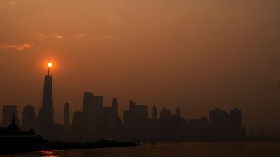 The sun rises behind the One World Trade Center, while the smoke from Canada wildfires covers the Manhattan borough as it is seen from Liberty State Park on June 8, 2023 in New Jersey. PHOTO BY EDUARDO MUNOZ ALVAREZ/GETTY IMAGES