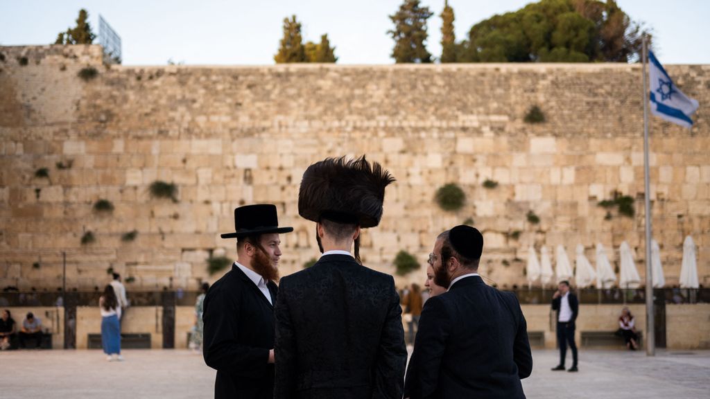 Ultra-Orthodox Jewish devotees arrive to pray at the Western Wall in the Old City of Jerusalem on June 11, 2023. According to the article, Orthodox Jews have an average of 3.3 children born per adult—more than double the 1.4, on average, for non-Orthodox Jews, per Pew.JEWEL SAMAD/AFP VIA GETTY IMAGES.