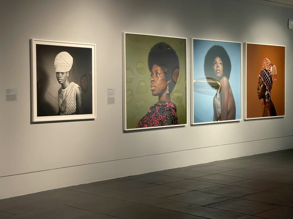 A wall displaying large portraits of Black women. 