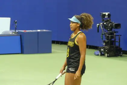 Naomi Osaka wearing a Kobe Bryant jersey during an exhibition tennis match (Photo by Derrel Jazz Johnson for rolling out)