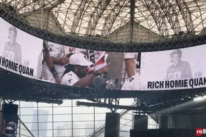 Pastor Troy puts up his index finger during the Atlanta Falcons' tribute to Rich Homie Quan