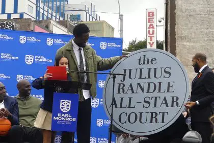 Julius Randle holds sign for "the Julius Randle All-Star Court" (Photo by Derrel Jazz Johnson for rolling out)