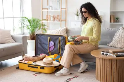 African American woman packing her luggage to travel for the holidays