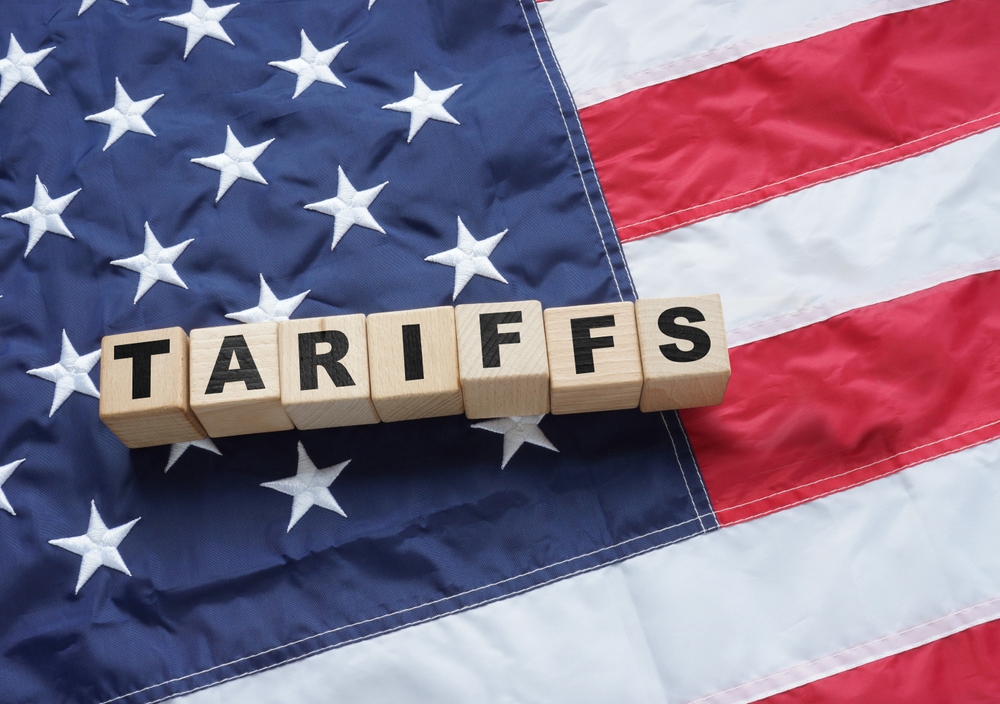 An image of tariffs spelt on the US flag